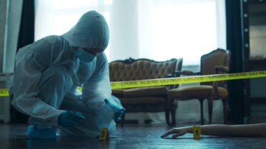 Detective Collecting Evidence in a Crime Scene. Forensic Specialists Making Expertise at Home of a Dead Person. The Concept of Homicide Investigation by Professional Police Officer.