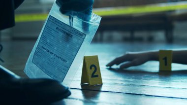 Detective Collecting Evidence in a Crime Scene. Forensic Specialists Making Expertise at Home of a Dead Person. The Concept of Homicide Investigation by Professional Police Officer.
