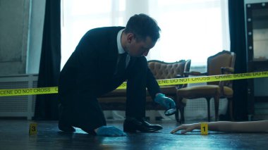 Detective Collecting Evidence in a Crime Scene. Forensic Specialists Making Expertise at Home of a Dead Person. The Concept of Homicide Investigation by Professional Police Officer.