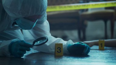 Detective Collecting Evidence in a Crime Scene. Forensic Specialists Making Expertise at Home of a Dead Person. The Concept of Homicide Investigation by Professional Police Officer.