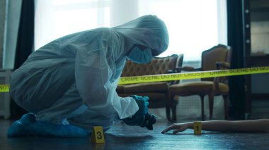 Detective Collecting Evidence in a Crime Scene. Forensic Specialists Making Expertise at Home of a Dead Person. The Concept of Homicide Investigation by Professional Police Officer.