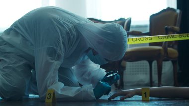 Detective Collecting Evidence in a Crime Scene. Forensic Specialists Making Expertise at Home of a Dead Person. The Concept of Homicide Investigation by Professional Police Officer.