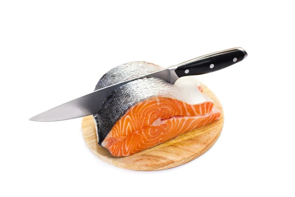 Fresh salmon on a round cutting board — Stock Photo, Image