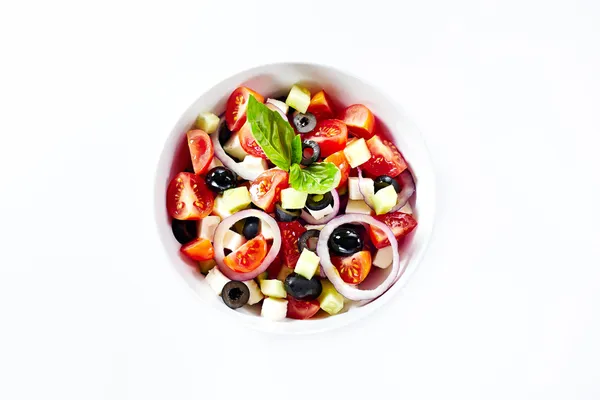 Light salad with vegetables and basil. Isolated on white backgro — Stock Photo, Image