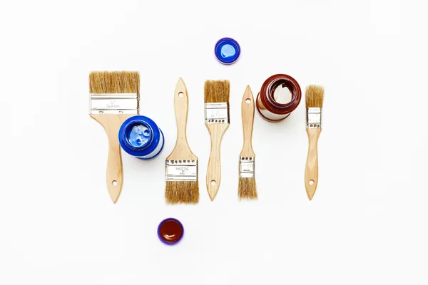 Set of five new renovation brushes with paint — Stock Photo, Image