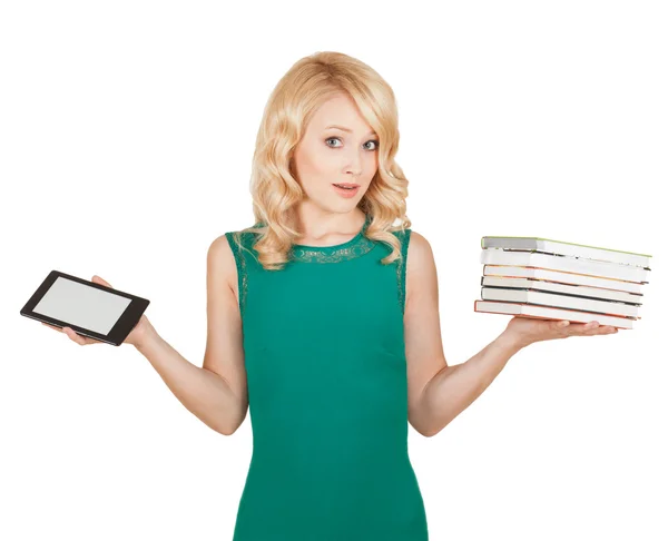 The beautiful, slender blonde compares a tablet and books — Stock Photo, Image