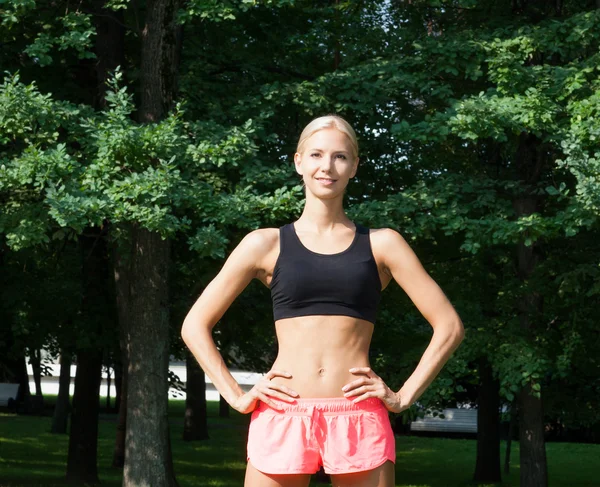 The beautiful blonde stretching outdoors — Stock Photo, Image