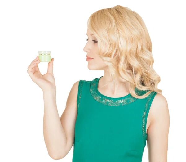 Beautiful blonde holds a cream jar in a hand — Stock Photo, Image