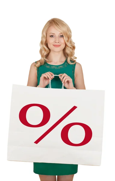 Beautiful blonde in a green dress holds a big package with purchases — Stock Photo, Image