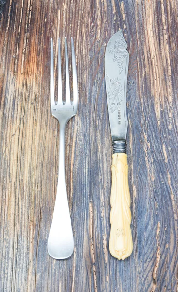 Vintage a knife a fork on a wooden board — Stock Photo, Image
