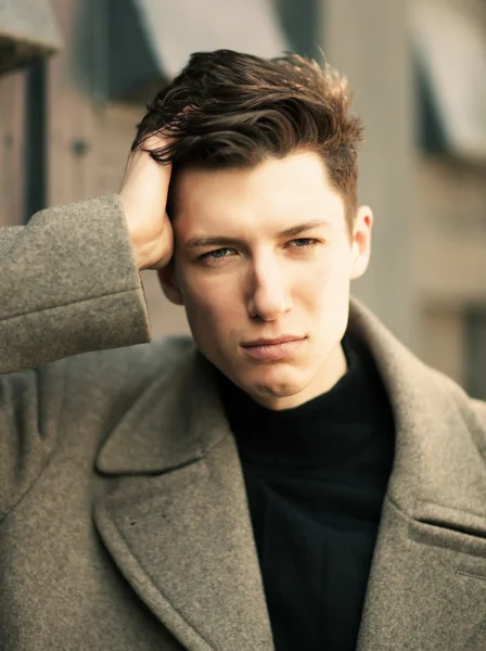 The young man poses in a coat.close up, image toned — Stock Photo, Image