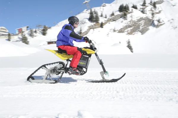 Man on snowmobile in the Swiss alps — Stock Photo, Image