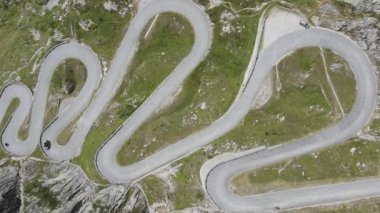 Drone view at cars on the old road to Gotthard pass in Switzerland 
