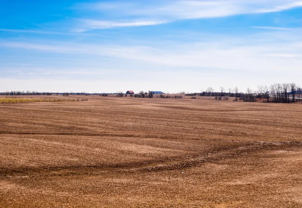 Empty brown farm fields on sky.