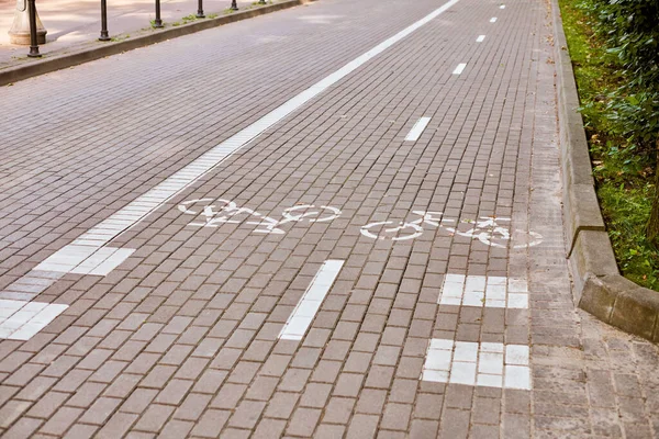 Two way cycle path, marking bike path on sidewalk, white painted bicycle sign on road on street. Bike road symbol. Ride on bicycle, cycling, bicycling, wheeling and healthy lifestyle concept