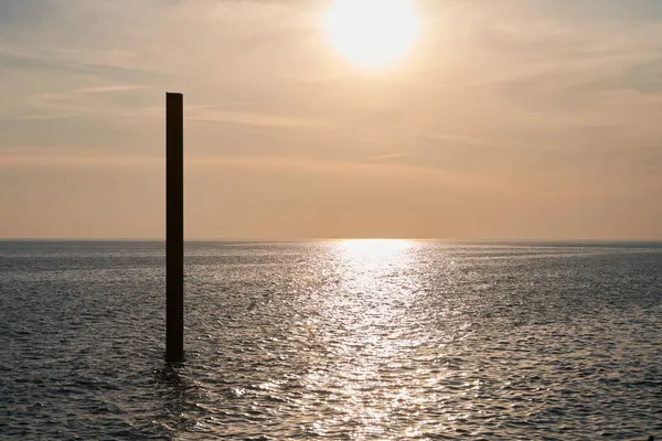 Large Rusty Steel Construction Pillar Blue Sea Calm Waves Sunset — Stock Photo, Image