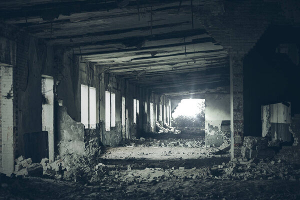 Abandoned building interior, spooky dark corridor in vintage dirty broken ruined abandoned premises, ruins of old industrial factory, grungy urban landscape background. Horror scene