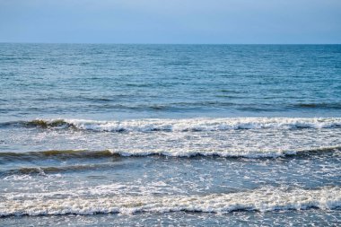 Derin mavi deniz suları köpüklü dalgalarla sıçrıyor. Okyanus manzarası, su sıçratan dalgalar, beyaz köpüklü koyu mavi dalgalı deniz suları. Su yüzeyi, doğal arkaplan, kopyalama alanı