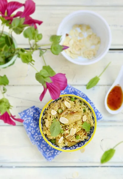 Pilaf with chicken, peas and almonds — Stock Photo, Image