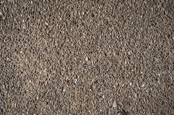Галька на фоні текстури асфальтового каменю — стокове фото