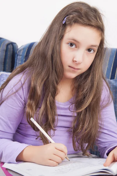 Girl writting homework — Stock Photo, Image