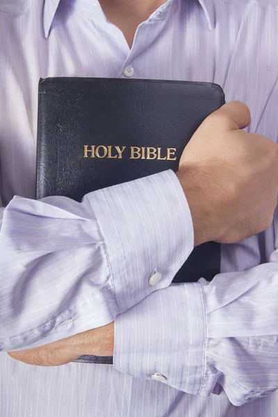 Hombre con camisa abrazando la Biblia — Foto de Stock