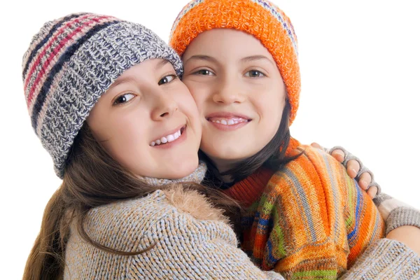 Beautiful young girls in warm winter clothes hugging — Stock Photo, Image