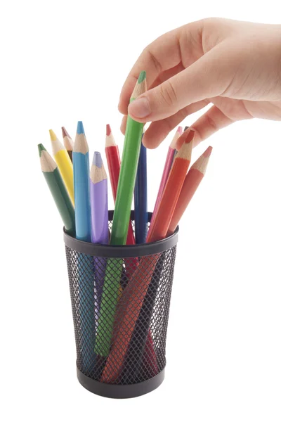 Hand taking color pencil from metal vase — Stock Photo, Image