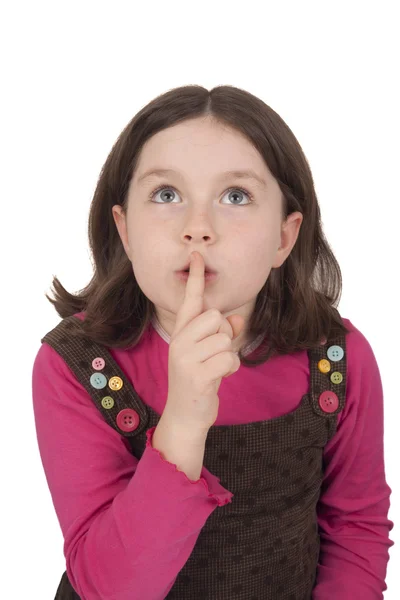 Beautiful little girl looking up and gesturing silence — Stock Photo, Image