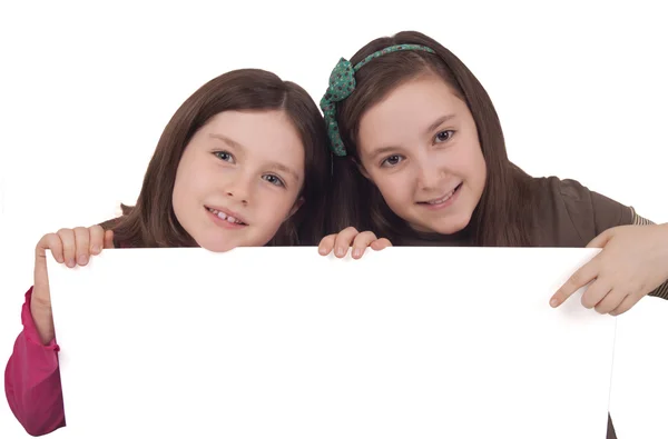 Two little girls holding a white banner — Stock Photo, Image