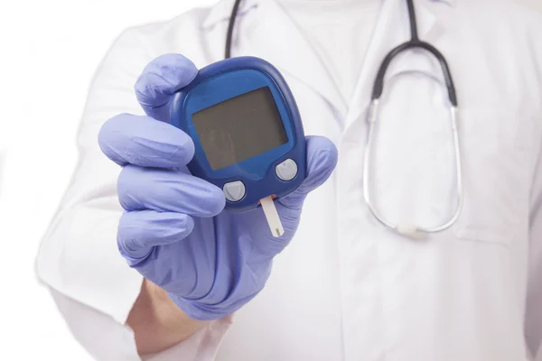 Doctor holding blood sugar meter — Stock Photo, Image
