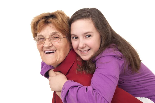 Grandmother giving granddaughter piggy back ride — Stock Photo, Image