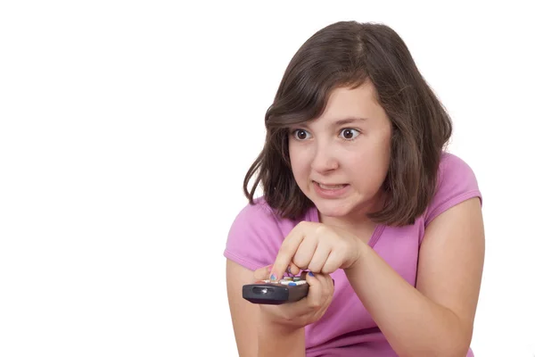 Belle adolescente avec télécommande tv dans ses mains — Photo