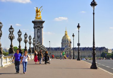 The Pont Alexandre III with the north front of the Invalides in the background in Paris. clipart
