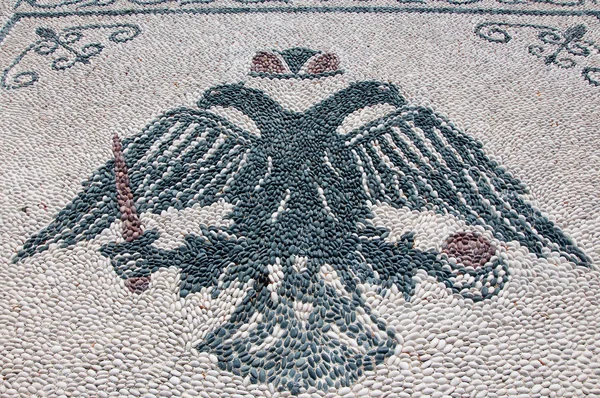 Pebble stone floor with a picture of double eagle, Rhodes. — Stock Photo, Image