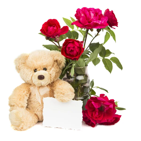 Teddybär und Blumen lizenzfreie Stockbilder