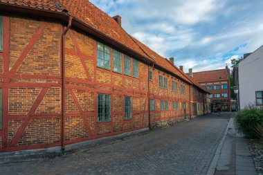 Ystad, Sweden - 6 Sep, 2022: Old half timbered building that houses smaller businesses in a smaller town, southern Sweden during early morning