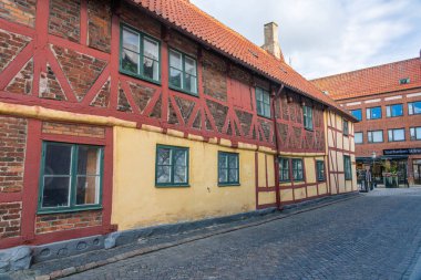 Ystad, Sweden - 6 Sep, 2022: Old half timbered building with a cobblestone street.