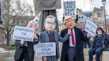 Londra, İngiltere, 5 Şubat 2022. Muhafazakâr hükümetin haksız seçim yasasını protesto etmek amacıyla düzenlenen Make Oy Meselesi mitinginde Boris Johnson, Michael Gove ve ve Donald Trump gibi giyinmiş protestocular.