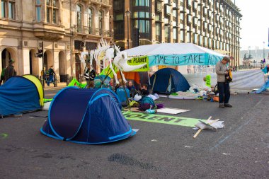 London, UK. 19th April 2019. Extinction Rebellion supporters occupy & block the road in Parliament Square, central London, with tents, in protest against world climate change and ecological collapse.