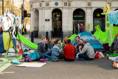 London, UK. 19th April 2019. Extinction Rebellion supporters occupy & block the road in Parliament Square, central London, with tents, in protest against world climate change and ecological collapse.