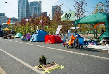 London, UK. 19th April 2019. Extinction Rebellion supporters occupy and block the road on Waterloo Bridge, central London, with tents, in protest against world climate change and ecological collapse.