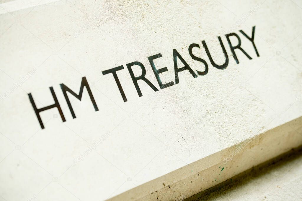 Angled view of HM TREASURY sign on Whitehall building in London, UK.