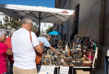 Cadiz, İspanya. 4 Eylül 2022. İspanya 'nın Cadiz kentindeki eski kasaba sokaklarında bit pazarı tezgahları. Yerel satıcılar meraklı turistlere ikinci el antika ve koleksiyon satıyorlar.. 