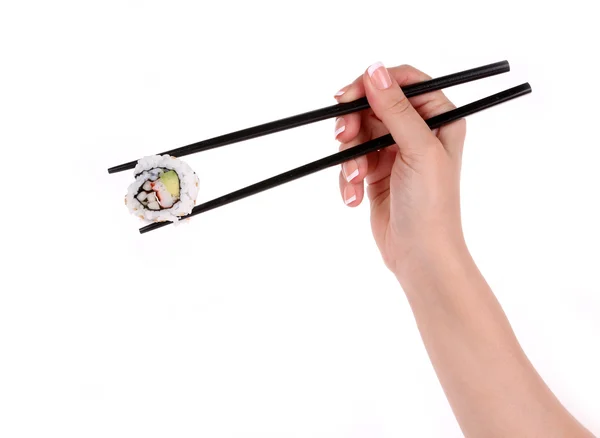 Rouleau de sushi avec baguettes noires à la main féminine isolé sur blanc Images De Stock Libres De Droits