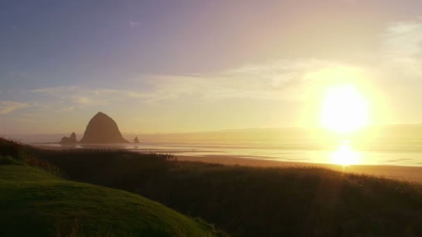 Man at Pacific Ocean near Cannon Beach looks out to sea as sun sets on beautiful day. — Stock Video