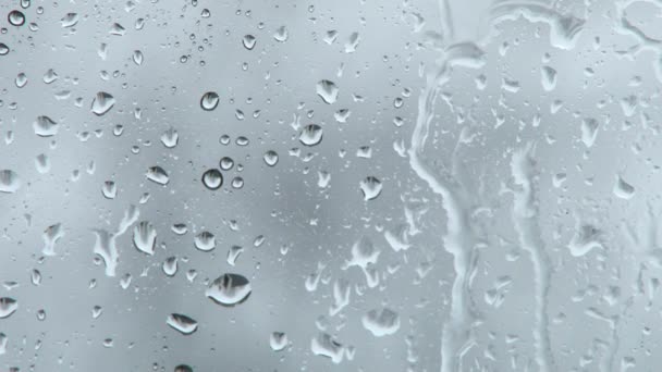 Rain falling on glass during rain storm. — Stock Video