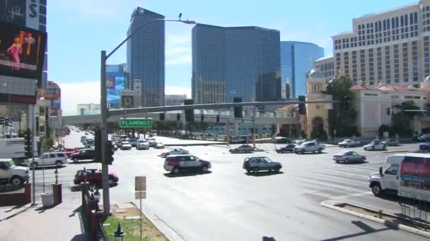 LAS VEGAS, NEVADA - CIRCA 2012 - Las Vegas Boulevard Strip with vehicles driving on sunny day by Flamingo Road intersection, camera boom down. — Stock Video