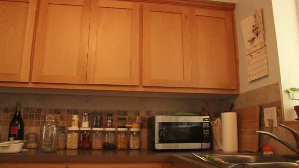 Man opens the microwave. a man with a cup shows sign OK — Stock Video