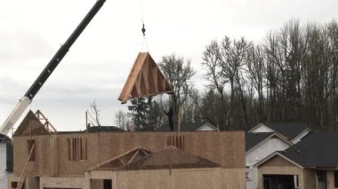 Rafterler mahallede inşa edilen yeni ev inşaatı için vinçleniyorlar..